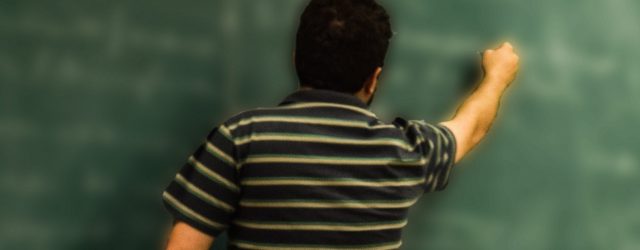 Teacher at chalkboard